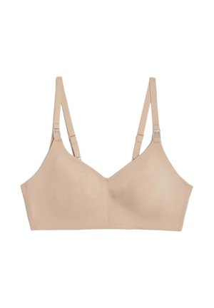 Beige trådløs bh med justerbare stropper, glat stof, minimalistisk design og ingen synlige sømme, med en scoop-udskæring.