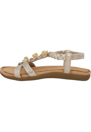 Flat sandal in metallic silver with braided straps and yellow floral accents. Cushioned footbed and flexible beige sole.