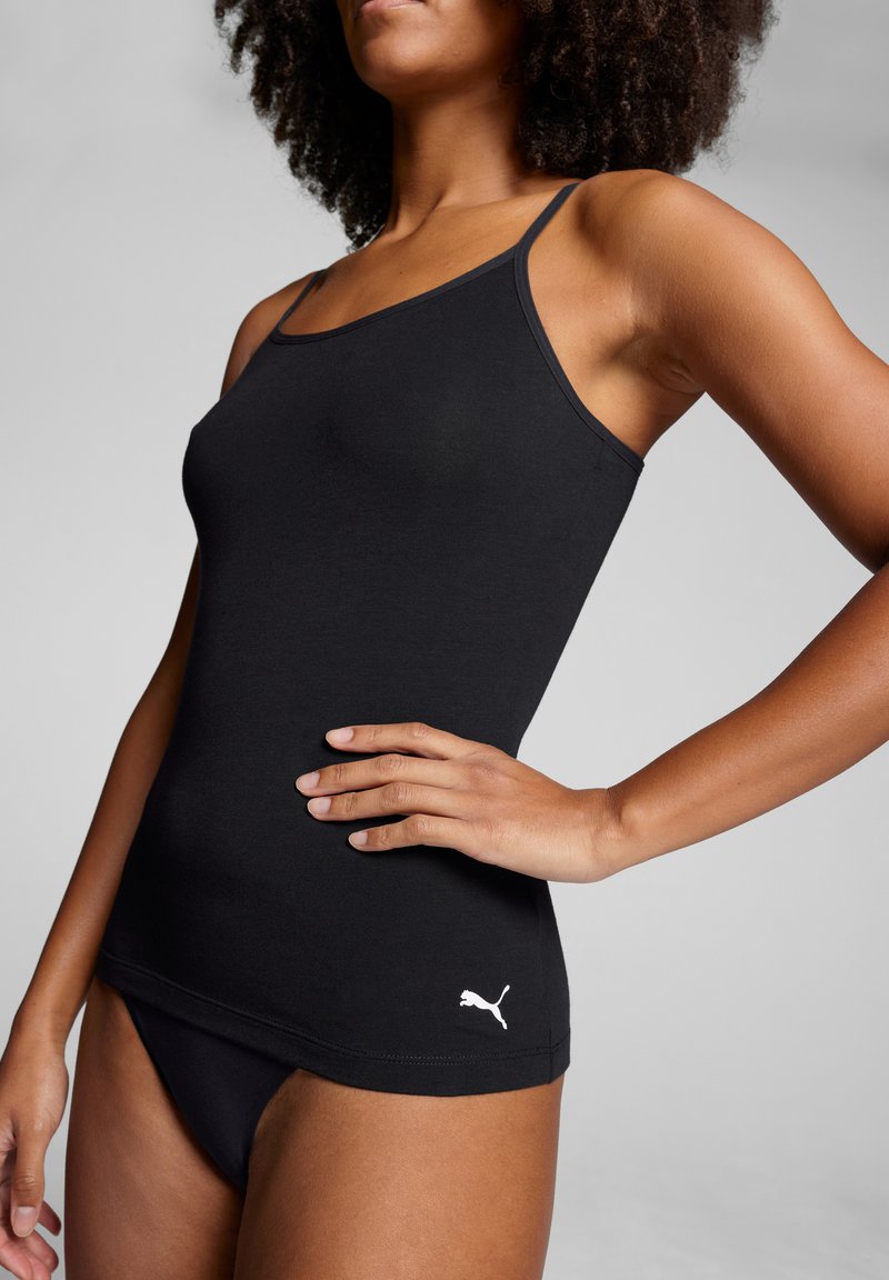 Black tank top made of smooth fabric with thin straps. Features a white logo on the left side near the hem. Sleek, fitted design.