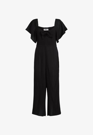 Crna kombinezon sa kratkim lepršavim rukavima, četvrtastim izrezom i detaljem mašne sprijeda. Izrađen od teksturirane tkanine s hlačama širokih nogavica.