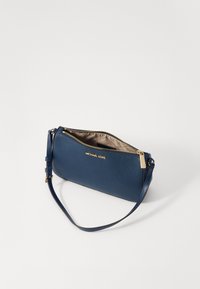 Blue leather clutch bag with a textured finish, gold zipper, and logo detail. Features a detachable strap for versatility.