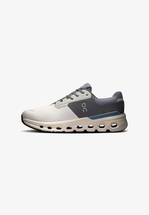 Lightweight running shoe in grey and white, featuring a breathable upper, cushioned sole, and hexagonal cutouts for added flexibility.