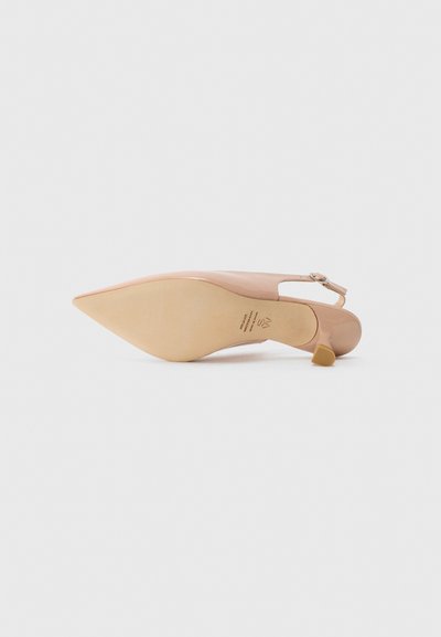 Nude patent leather high-heeled shoe with a pointed toe and adjustable ankle strap. Textured sole with a low, block heel.