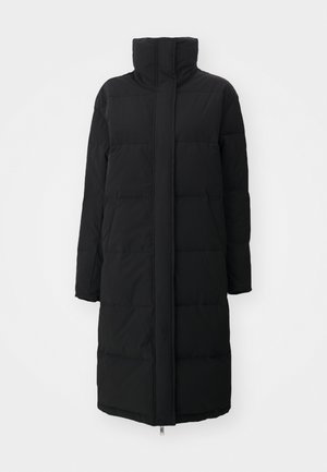 Must have kõrge kaelusega must pehme jope, pika varrukaga ja küljetaskutega; omab sirget lõiget ja siledat, tekstuurset kangast.