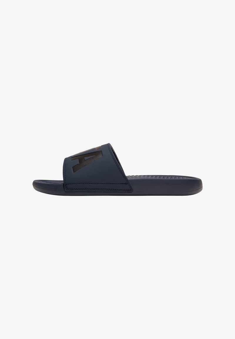 Navy slide sandal made of smooth synthetic material with a wide strap featuring a black logo. Textured outsole for grip, flat design.