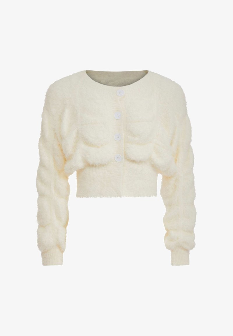Cardigan scurt, pufos, de culoare crem, cu mâneci lungi bufante și patru butoane albe pe față.