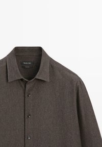 Dark brown button-up shirt featuring a textured fabric, a collar, and black buttons. Label indicates brand "Massimo Dutti," made in China.