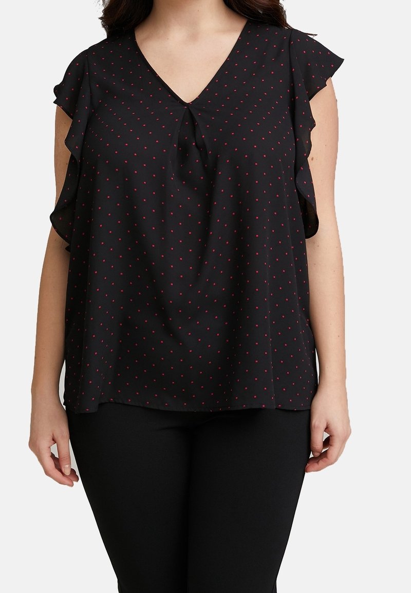 Black blouse with short ruffled sleeves, V-neckline, and red polka dots. Lightweight fabric with a relaxed fit and a tie detail at the front.