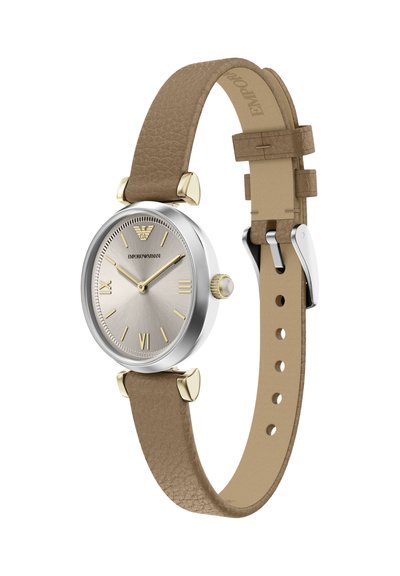 Round stainless steel watch with a silver dial, gold accents, and a light brown leather strap. Features Roman numerals and a textured finish.