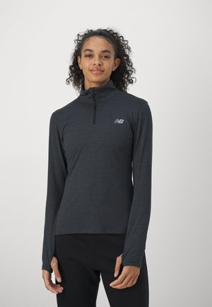 Long-sleeve quarter-zip top in dark grey, made of lightweight, textured fabric. Features a small logo on the chest and fitted cuffs.