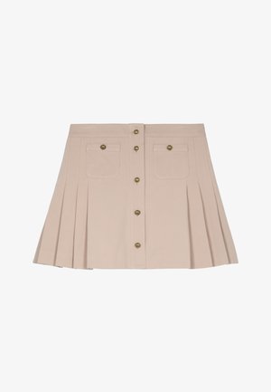 Jupe plissée beige avec deux poches avant, boutons en laiton et taille ajustée. Le tissu semble lisse et structuré.