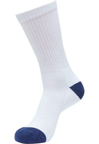 Weißer Baumwollsocken mit vertikaler Rippung, marineblaue Akzente an Ferse und Zehen. Glatte Textur, knöchelhoch.