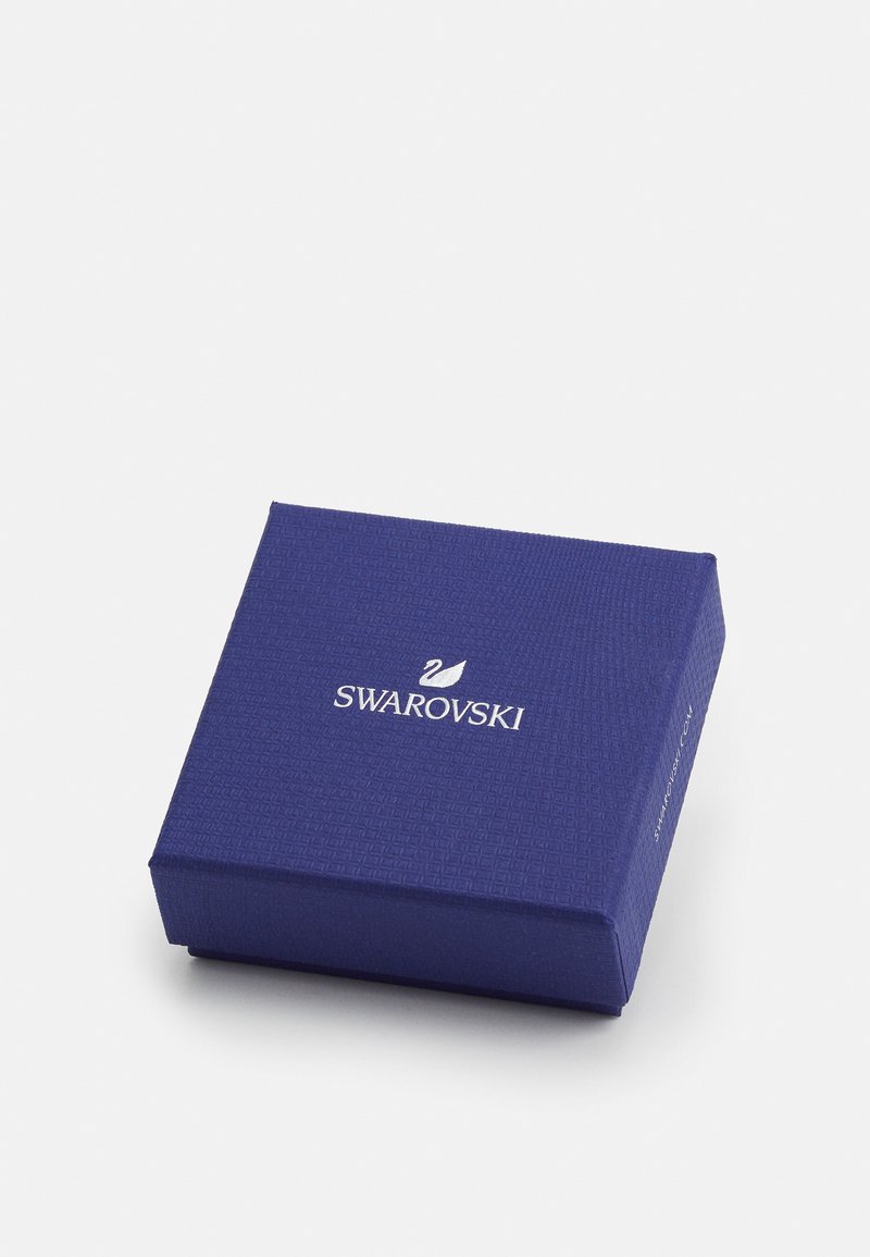 Boîte-cadeau Swarovski en matériau texturé bleu foncé, de forme carrée avec un logo blanc sur le dessus. Design classique et élégant pour l'emballage.