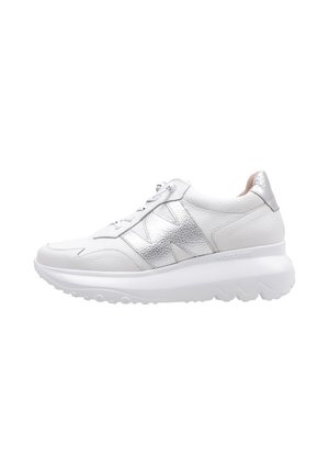 Zapatilla blanca con cuero texturizado y acentos metálicos plateados, que presenta una suela acolchada y un diseño de punta redondeada.