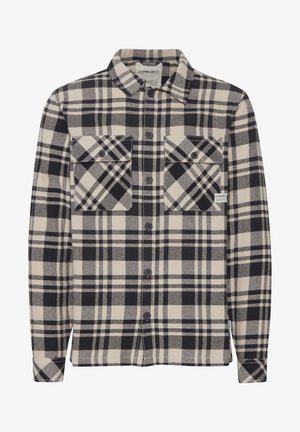 Black and cream plaid shirt made of flannel; features a button-up front, two chest pockets, and a collar. Textured fabric.