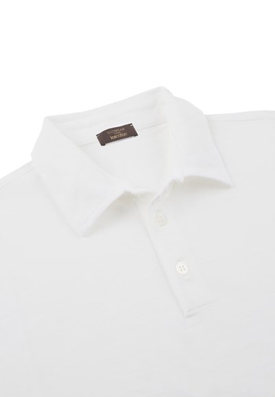 Witte polo-shirt van zacht katoen, met een klassieke kraag, drie knopen bij de hals en een subtiele logo-tag bij de halslijn.