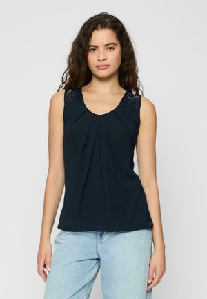 Top senza maniche blu navy con pieghe e dettagli in pizzo sulle spalle. Tessuto morbido con scollatura rotonda, che offre una vestibilità rilassata.