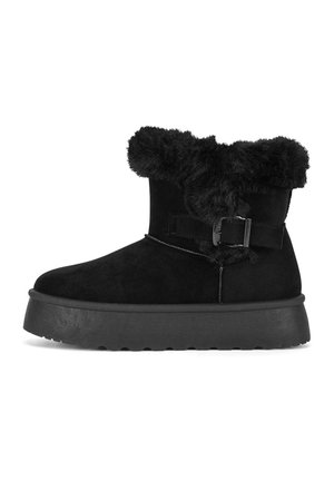 Black ankle boot with thick rubber sole, fluffy fur cuff, and decorative buckle on the side.