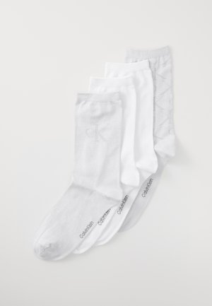 Set of four socks in white and light gray. Cotton blend, varying textures, with Calvin Klein branding on the footbed and side.