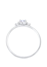 Simple silver ring featuring a central clear stone, flanked by two smaller stones. Smooth band with polished finish, minimalist design.