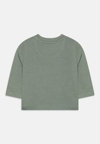 Grünes Kurzarmshirt mit Rundhalsausschnitt, aus strukturiertem Baumwollstoff. Zeichnet sich durch saubere Nähte und ein schlichtes Design aus.