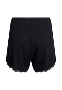 Svarta bomullsshorts med ribbad textur, elastisk midja och scallop-lace detaljer vid nederkanten, designade för komfort och passform.