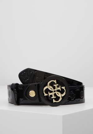 Black vinyl belt with embossed logos and round buckle featuring intertwined gold-tone Guess initials.