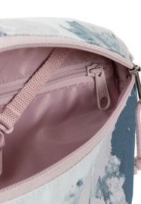Borsa in tessuto con motivo floreale e interno rosa, dotata di tasca con zip e un esterno testurizzato e resistente nei toni del blu e bianco.