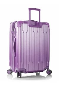 Hard-shell suitcase in glossy purple aluminum with vertical ridges, retractable handle, dual wheels, and zipper closure.