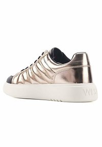 Metallic rose gold sneaker with a textured upper, white sole, black accents, and a rounded toe. Features horizontal ridges and lace closures.