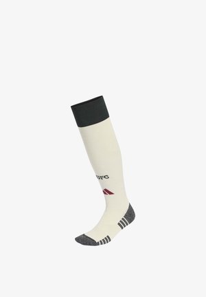 Weißer knielanger Socken mit schwarzem Bündchen, grauer Ferse und Spitze, schwarzen Streifen nahe den Zehen und einem kleinen burgunderfarbenen Logo mit schwarzem Text an der Seite.