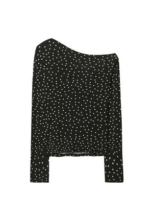 Schwarzes Langarmshirt mit schulterfreier Gestaltung, versehen mit weißen Punkten, aus weichem Material und im entspannten Schnitt.