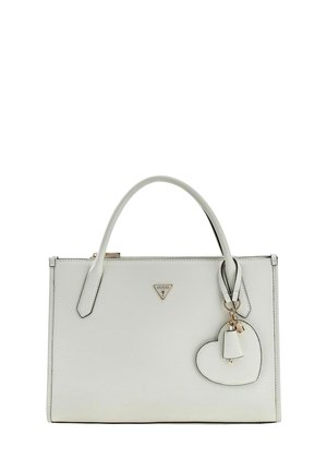 Sac à main rectangulaire blanc avec deux poignées, un pendentif en forme de cœur et une petite cloche suspendue à une poignée, avec un petit logo triangulaire.