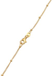 Guldkæde armbånd med en hummerlås, med et delikat design og glat tekstur. Kæden inkluderer små runde accenter langs sin længde.