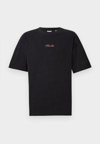 Black short-sleeve crew neck t-shirt with small red cursive text "Turbo" centered on the chest against a plain light background.