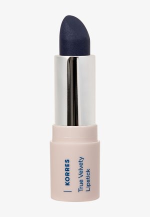 Korres True Velvety Lipstick in a sleek silver and pale pink tube. Features a rounded, dark blue, matte lipstick bullet.