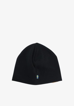 Black knit beanie hat featuring a small flag emblem in blue and yellow at the side. Soft texture with a fitted shape.