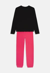 Camiseta negra de manga larga con cuello redondo y pantalones de chándal rosas con puños elásticos. Material de mezcla de algodón, diseño sencillo, sin patrones ni acentos.