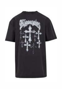 Sort bomulds T-shirt med et grafisk print af flere sølvkors og ordet "Migonazles" ovenfor, i fed skrift. Korte ærmer.