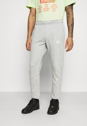 Gray cotton sweatpants with a tapered fit, featuring an elastic waistband and a small white Nike logo on the left thigh.