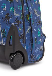Blue rolling backpack featuring aquatic patterns of octopuses and sharks, with black plastic wheels and a solid base for stability.