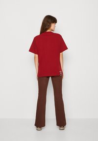 Puma Tričko s potlačou - intense red