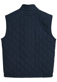 Navy blue quilted vest with a high collar, featuring diamond-pattern stitching, elastic hem, and a subtle branding label at the back.