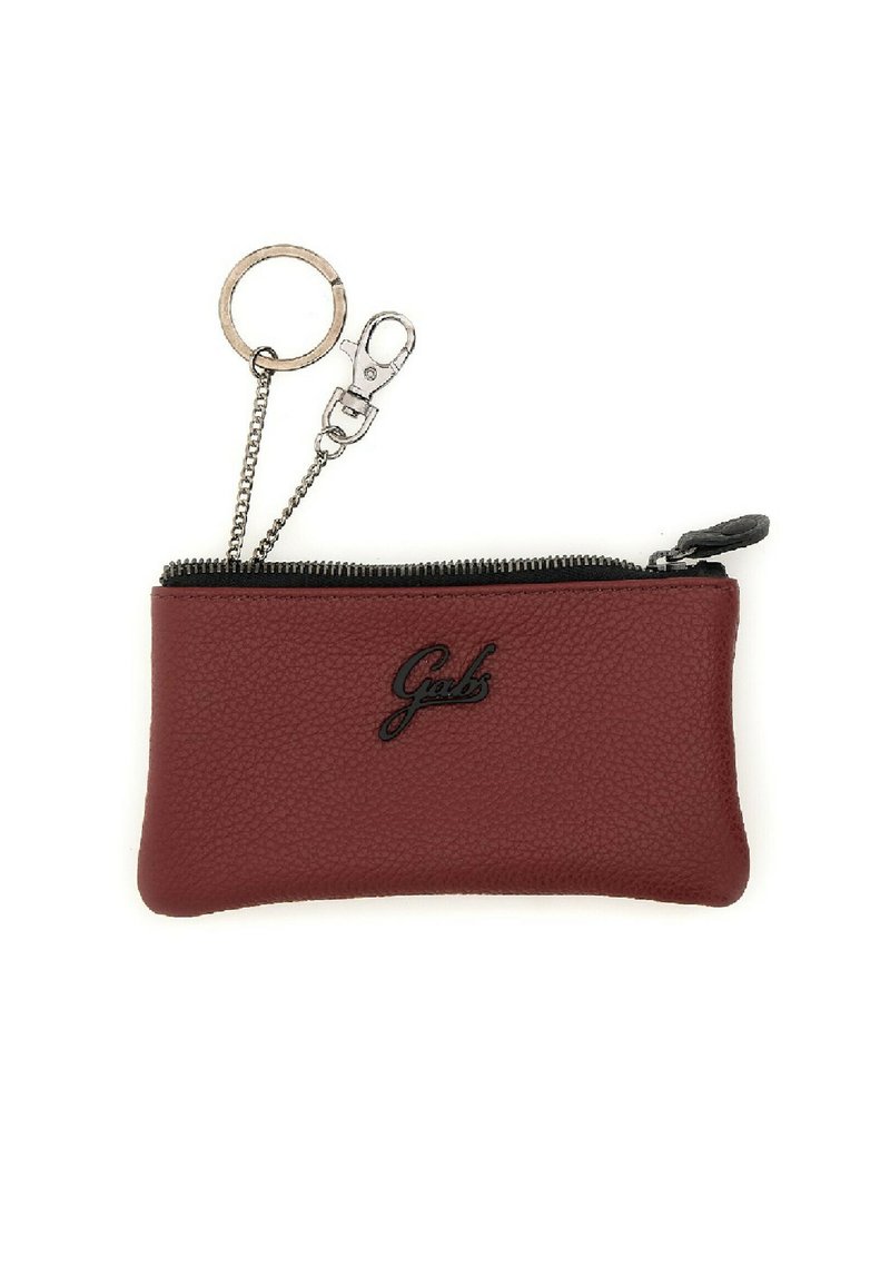Pochette in pelle rossa con texture, chiusura con zip nera e logo. Presenta una catena argentata con anello e clip per il fissaggio.
