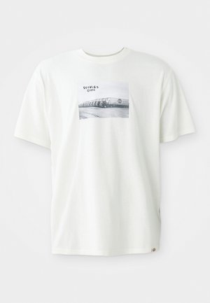 White cotton t-shirt featuring a rectangular black-and-white graphic print with "DICKIES 1922" text. Short sleeves and relaxed fit.