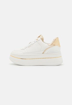 Leather platform sneaker in white with gold accents, featuring a textured gold heel, round laces, and a smooth sole with a thin gold stripe.