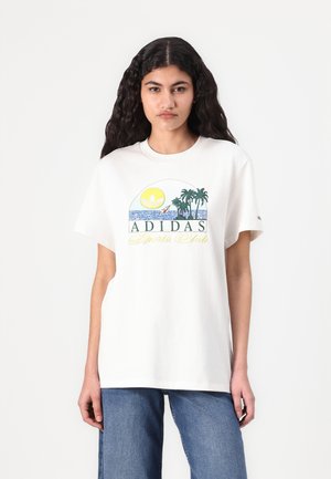 White cotton T-shirt featuring a colorful graphic with palm trees, sun, and "ADIDAS Sports Club" text. Relaxed fit with short sleeves.