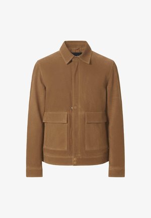 Kerge ja tekstuuriga pruun jakk, millel on krae, nööbid ees ja kaks suurt taskut ees. Sile kangas, mis on keha lähedale lõigatud.