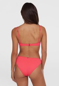 Élénk rózsaszín bikini szett egyszerű dizájnnal, vékony, állítható pántokkal és hátul zárható csattal. Simma textúra.