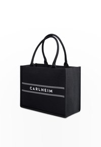 Černá taška na rameno se strukturovaným designem, s názvem značky "CARLHEIM" napsaným bílými písmeny a dvěma vodorovnými bílými pruhy.